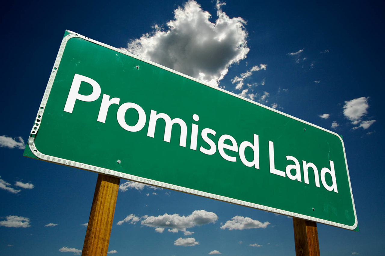 Photo of a fictional street sign saying Promised Land